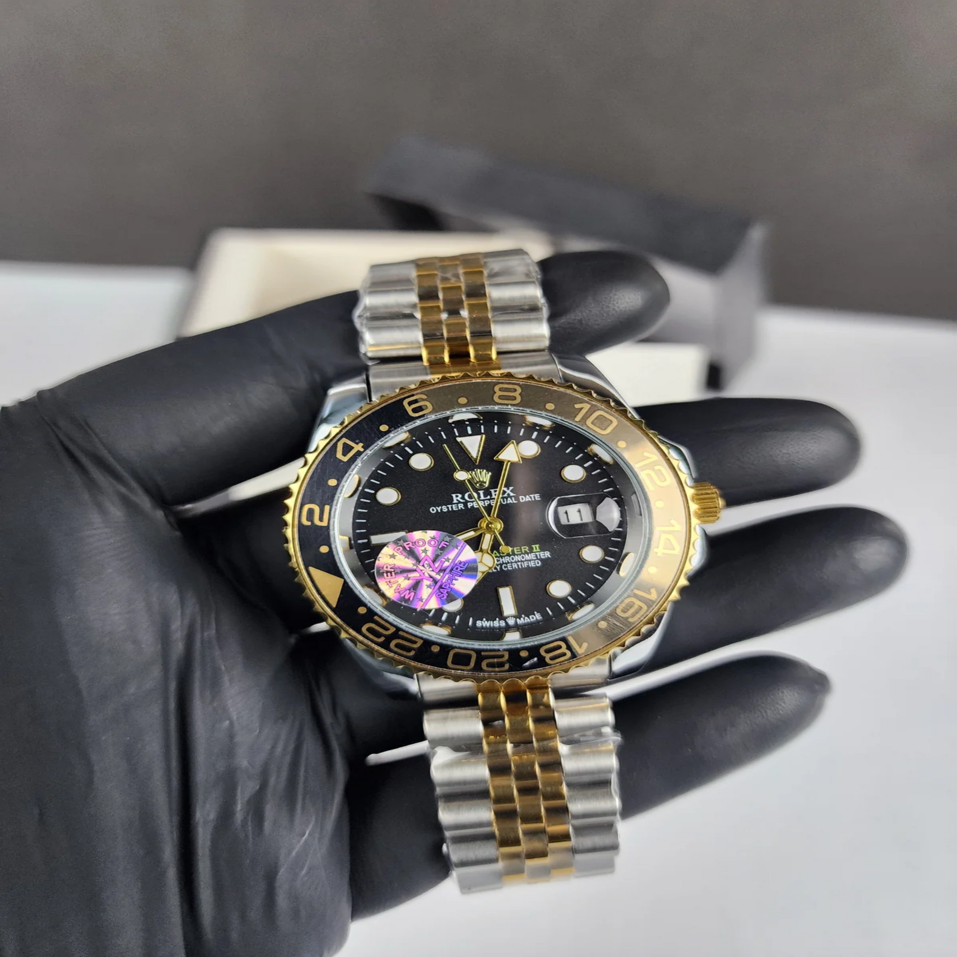 Two-tone gold and steel GMT Master style watch with black dial
